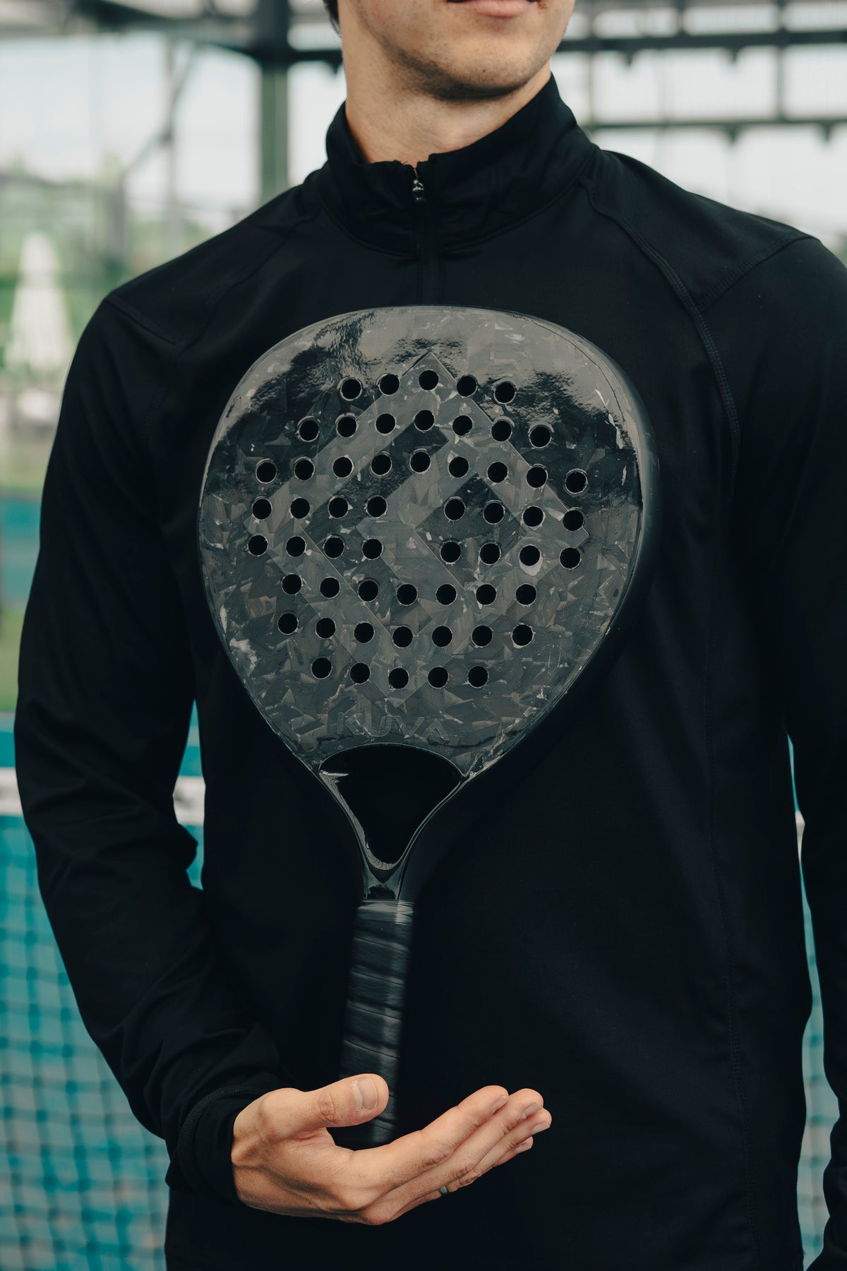 Stealth forged-carbon racket held on court